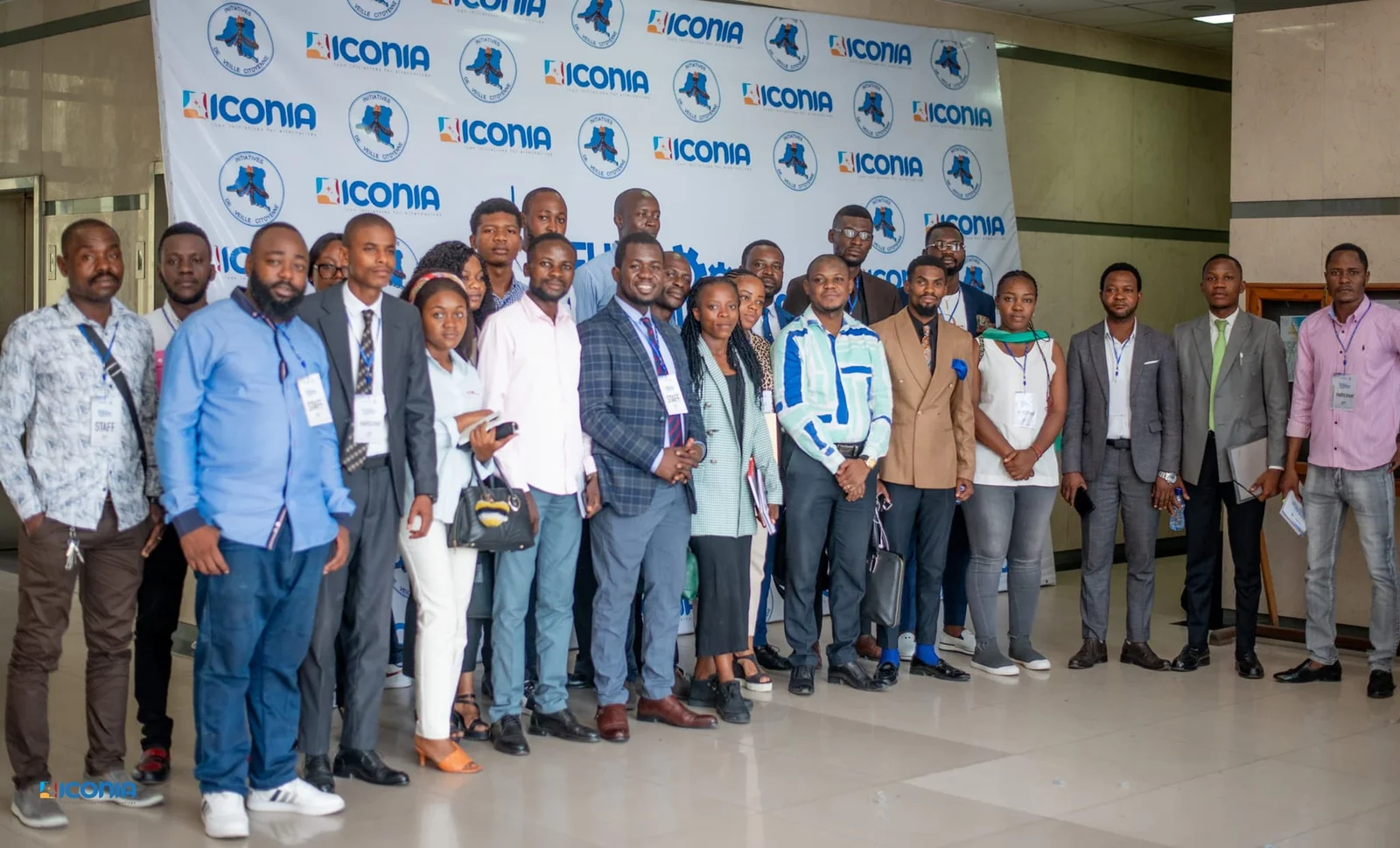 Group photograph in front of ICONIA and Nouvelle citoyenneté banners.